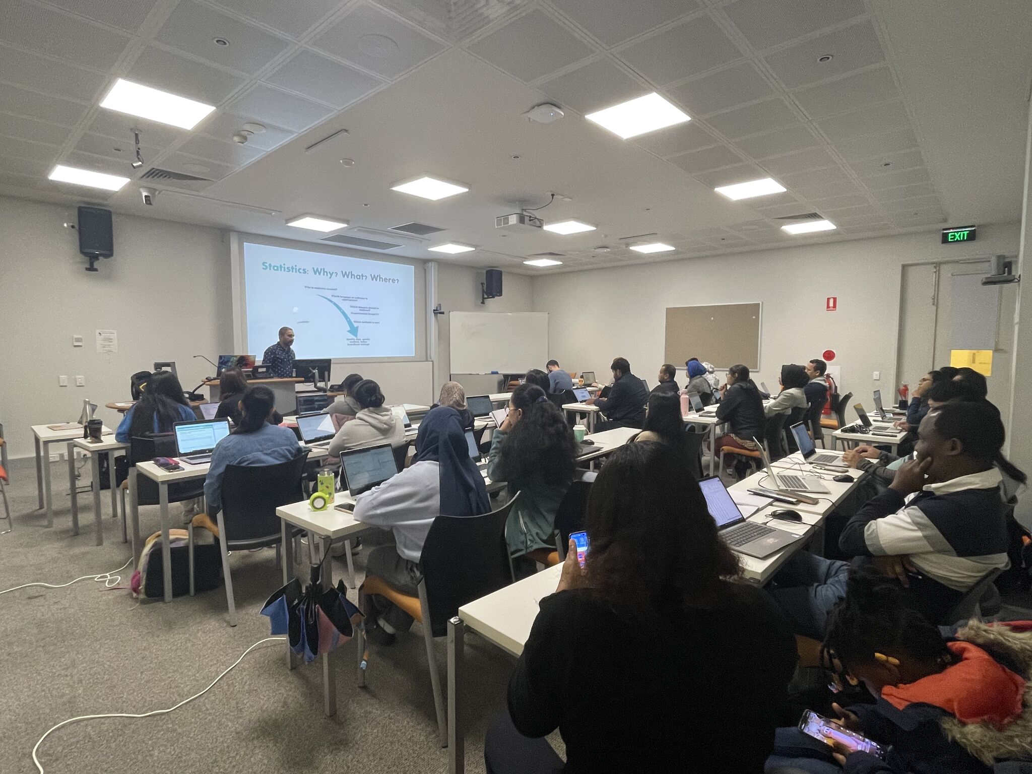 Workshop session in progress, presenter at the front of a lecture theatre
